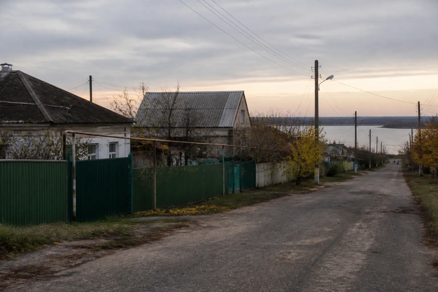 A quiet street in a small river town in southern Ukraine's Kherson region at dawn.