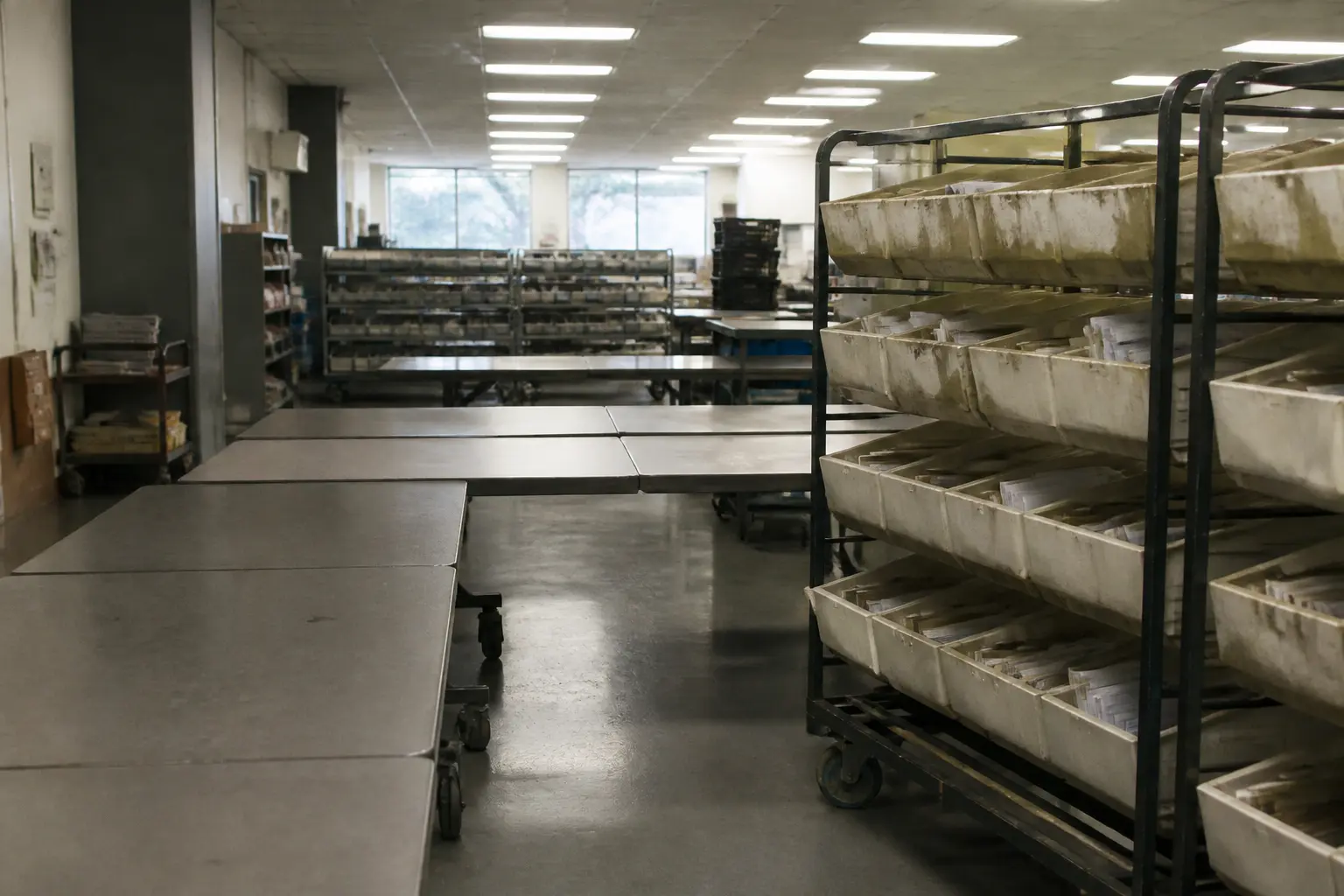 An empty county election office with sorting tables and mail trays in California